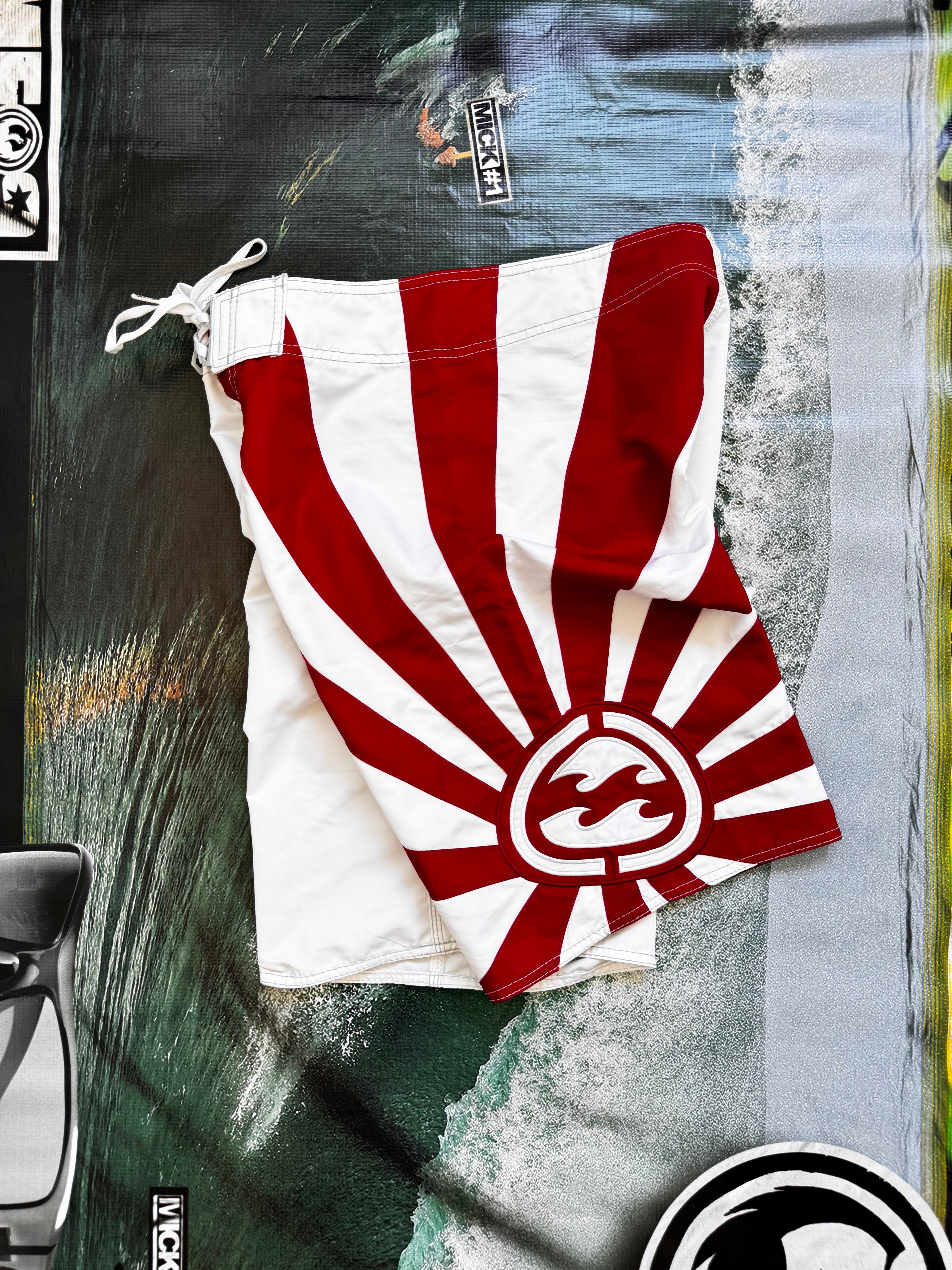 Vintage Y2K Billabong Andy Irons Rising Sun boardshorts in white and red, front view