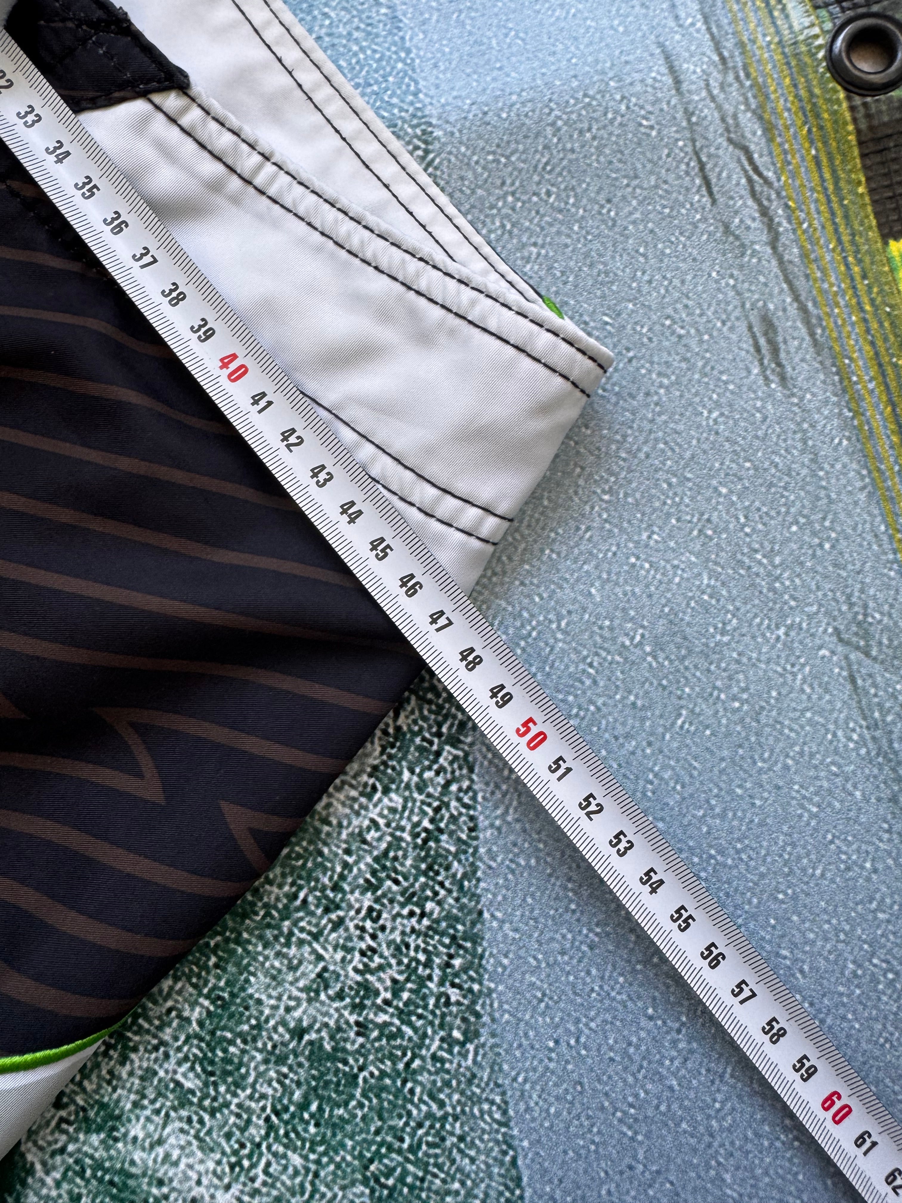 Vintage Y2K Rip Curl Mick Fanning boardshorts, flat lay