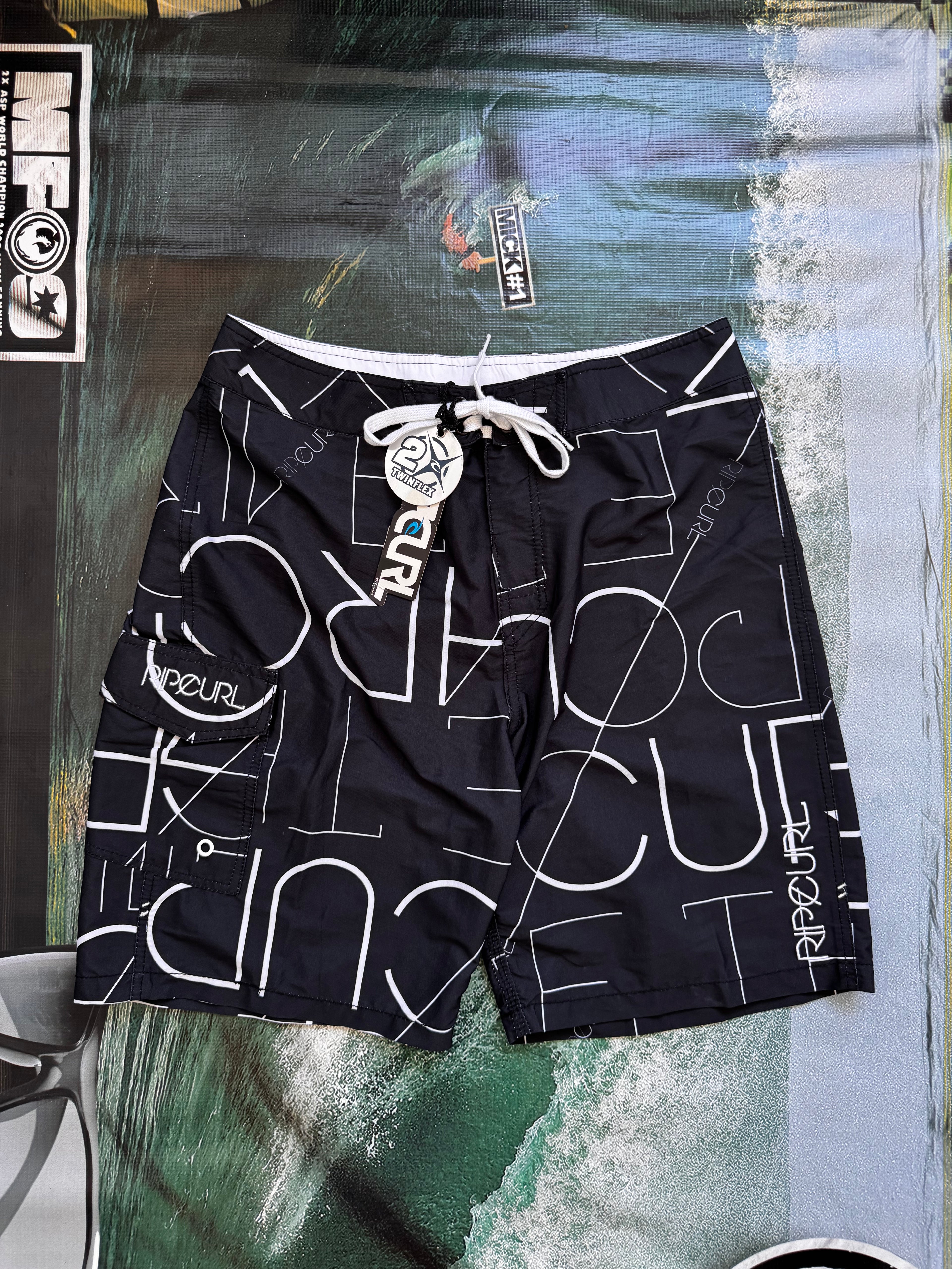 Vintage Y2K Rip Curl boardshorts in navy and white, front view