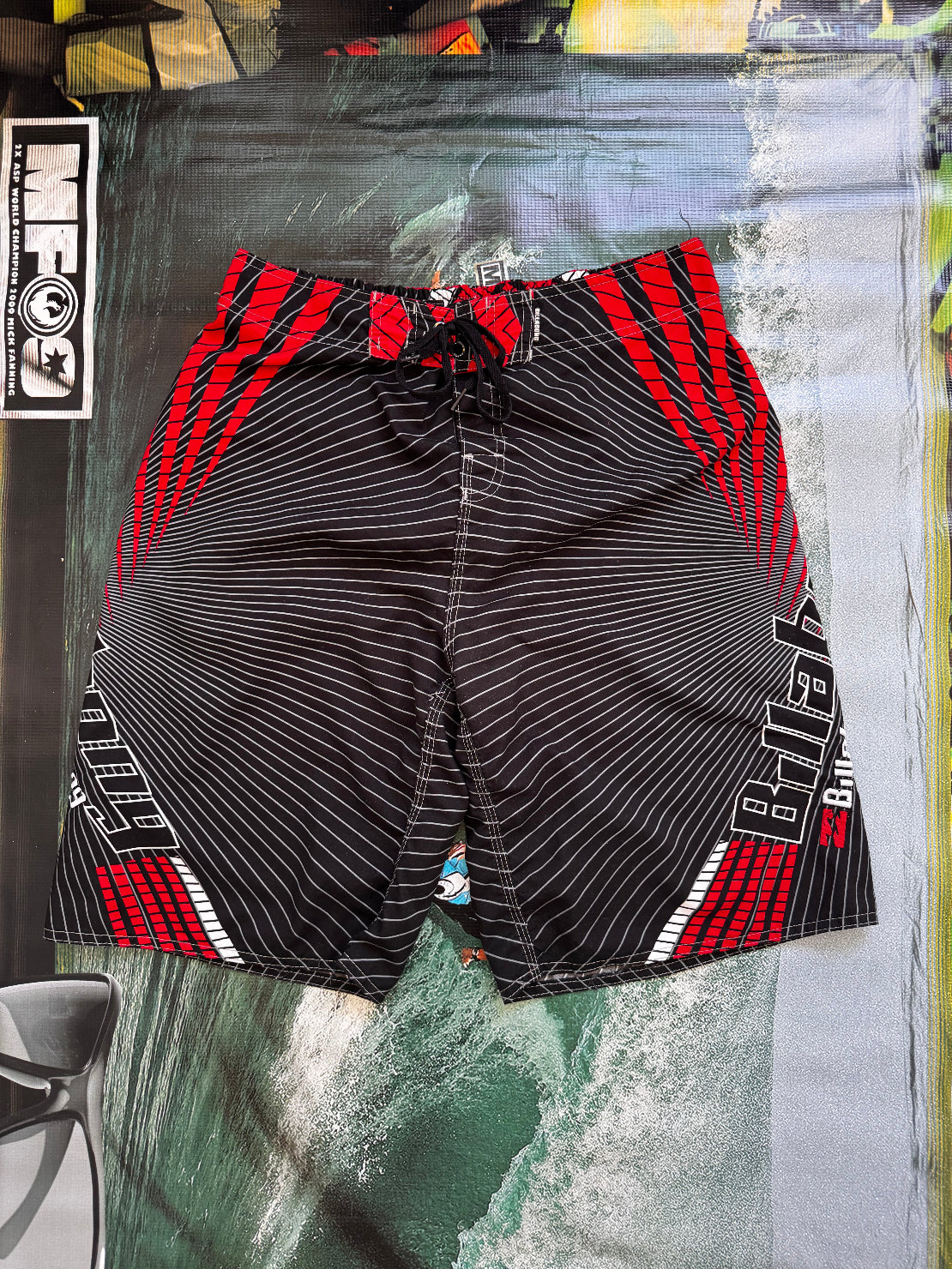 Vintage Y2K Billabong boardshorts in black and red, back view