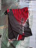 Vintage Y2K Billabong boardshorts in black and red, front view