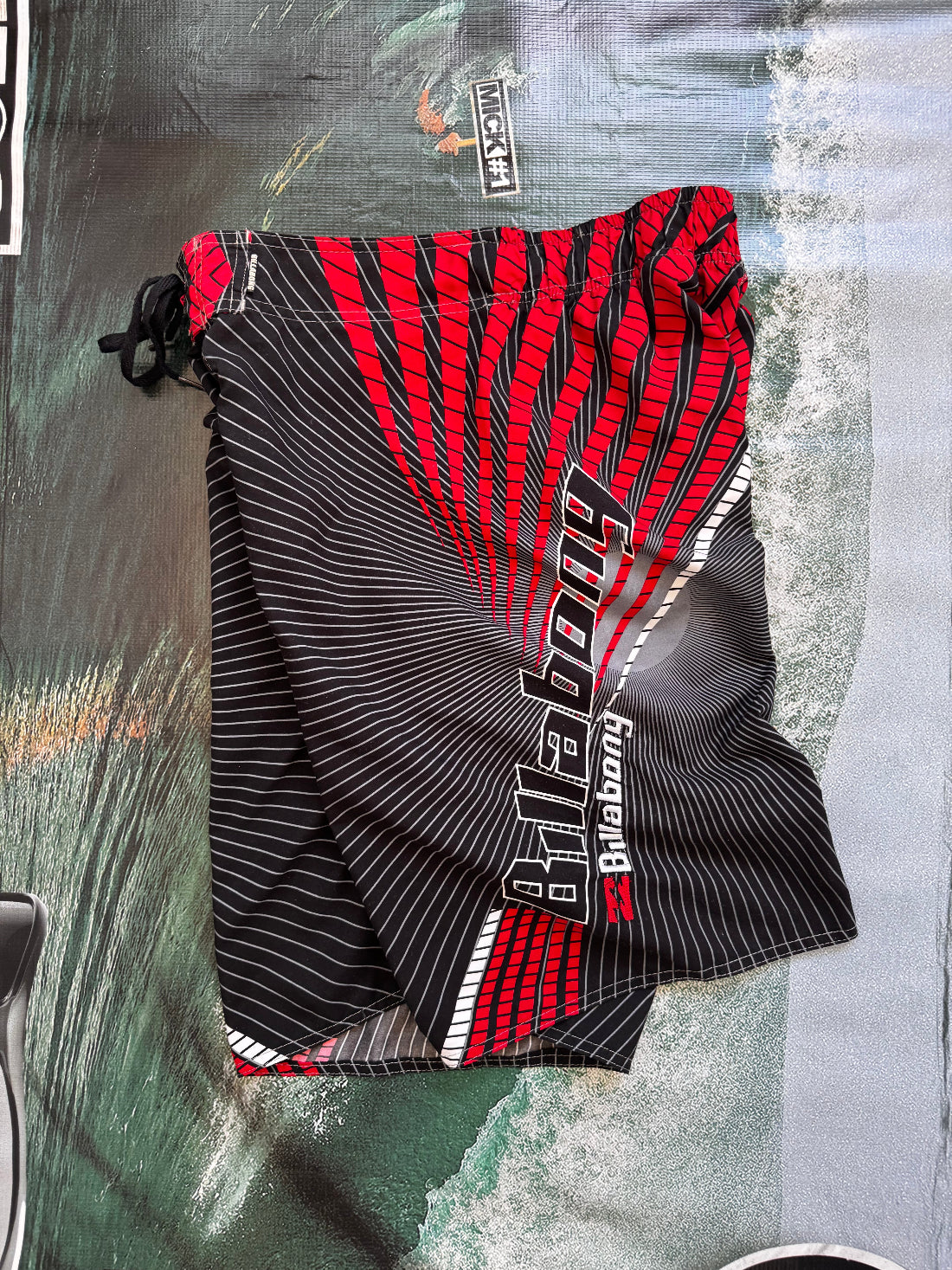 Vintage Y2K Billabong boardshorts in black and red, front view