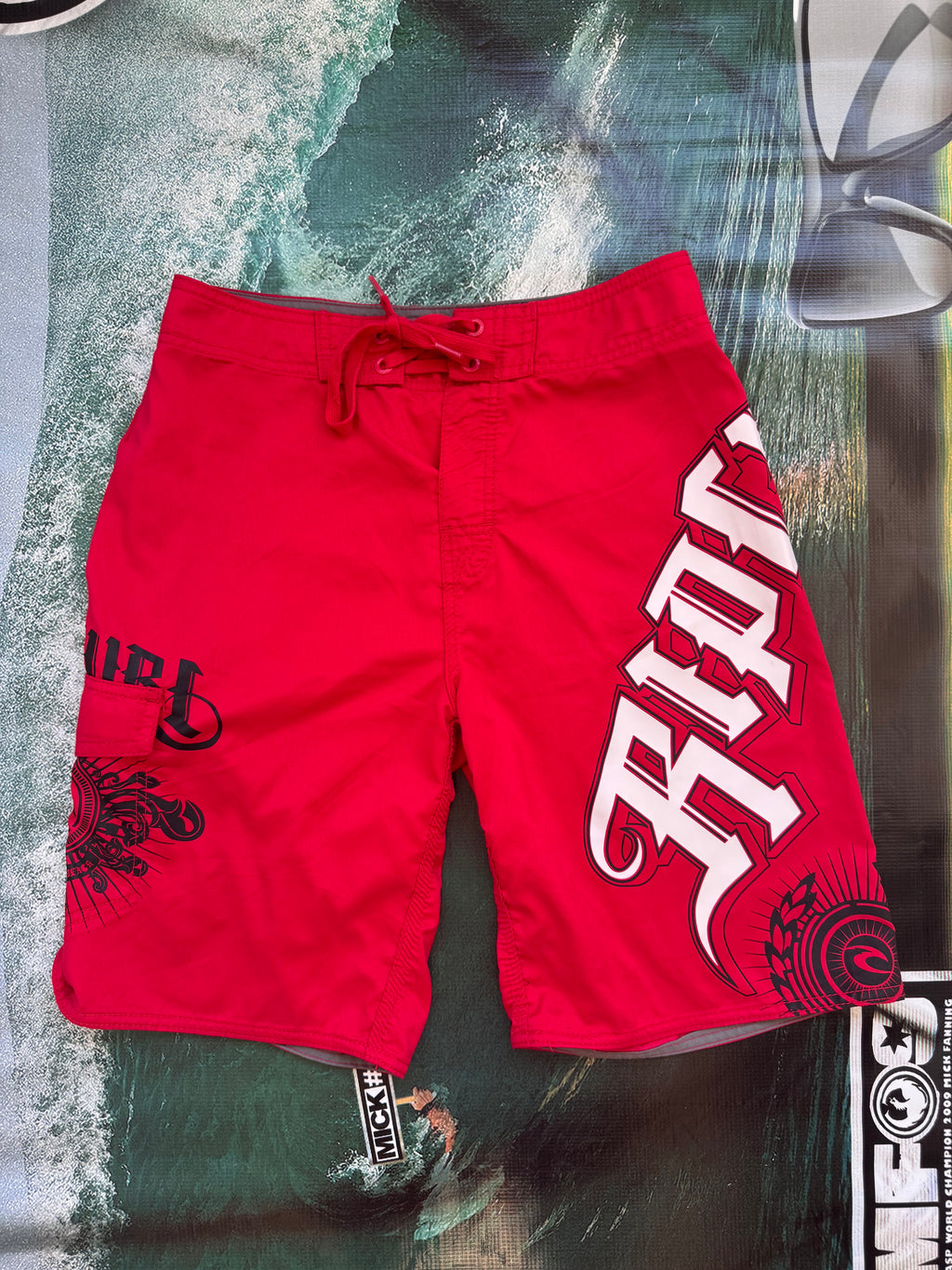 Y2K Rip Curl boardshorts in red, size 28, vintage surf shorts - front view