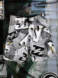 Vintage Y2K Billabong boardshorts in white, grey and black, front view